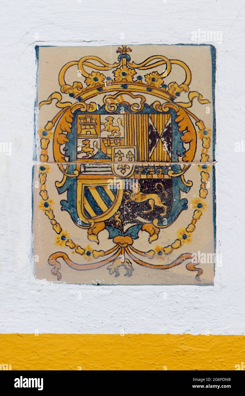 Royal Alcazars of Seville. Coat of arms glazed tiled from Patio de Banderas Section. Stock Photo