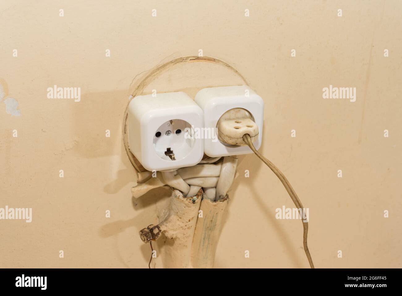 New socket, old plug electrical wiring in the house. Stock Photo