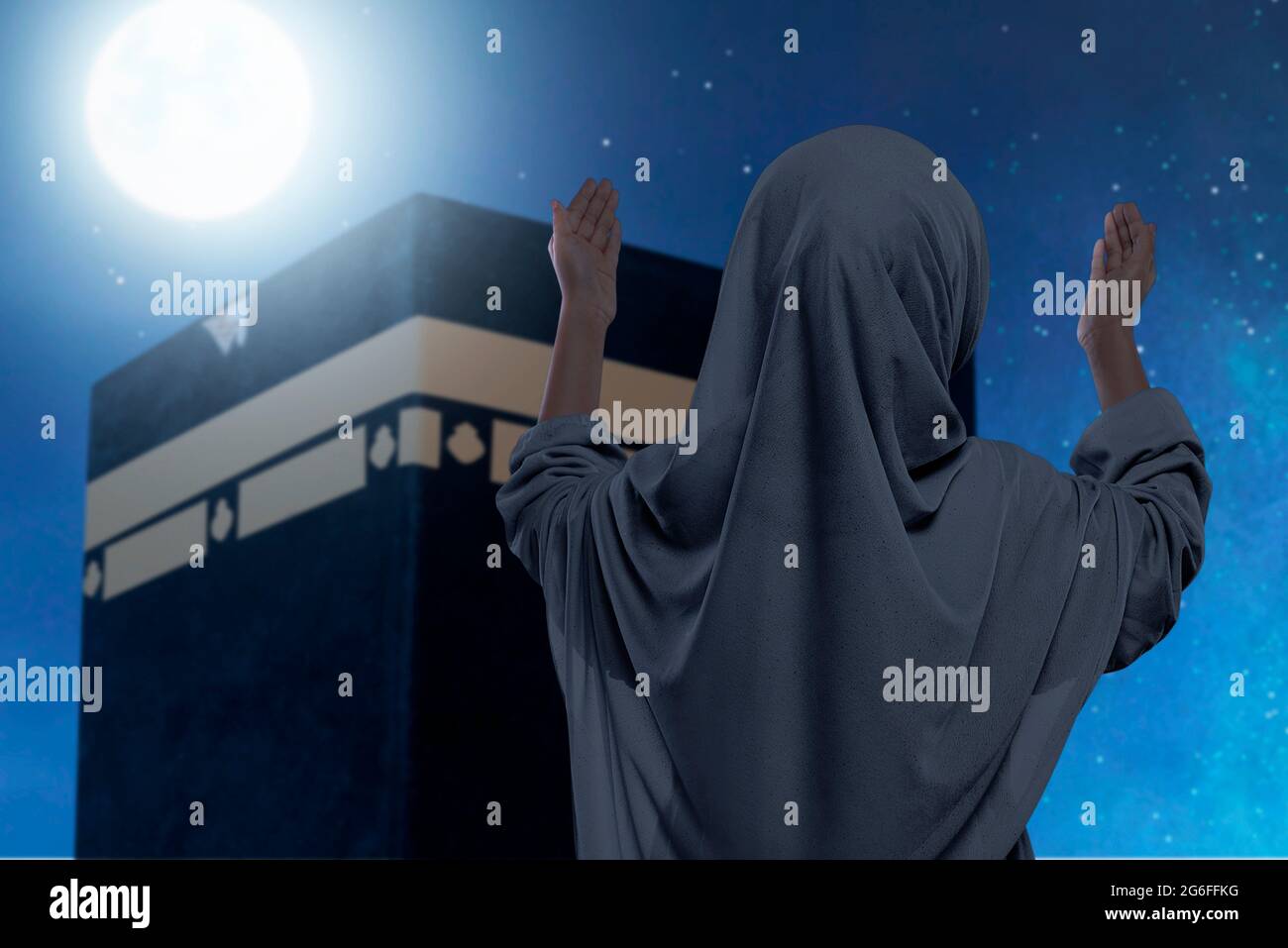 Rear view of Asian Muslim little girl in a veil standing and raised ...
