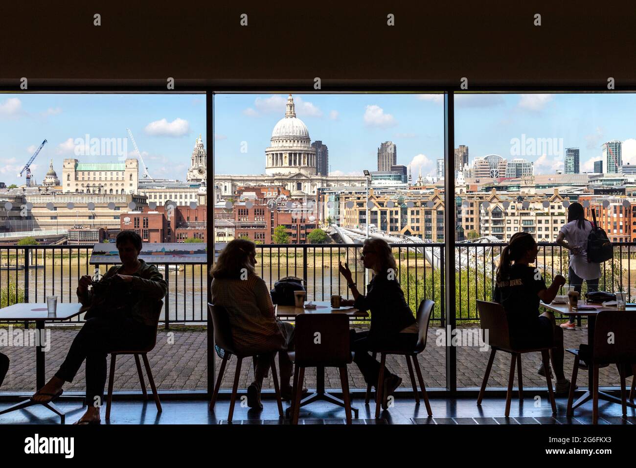 Silhouettes of people at the cafe overlooking St Pauls, Thames river and Millannium Bridge in Tate Modern museum of contemporary art, London, UK Stock Photo