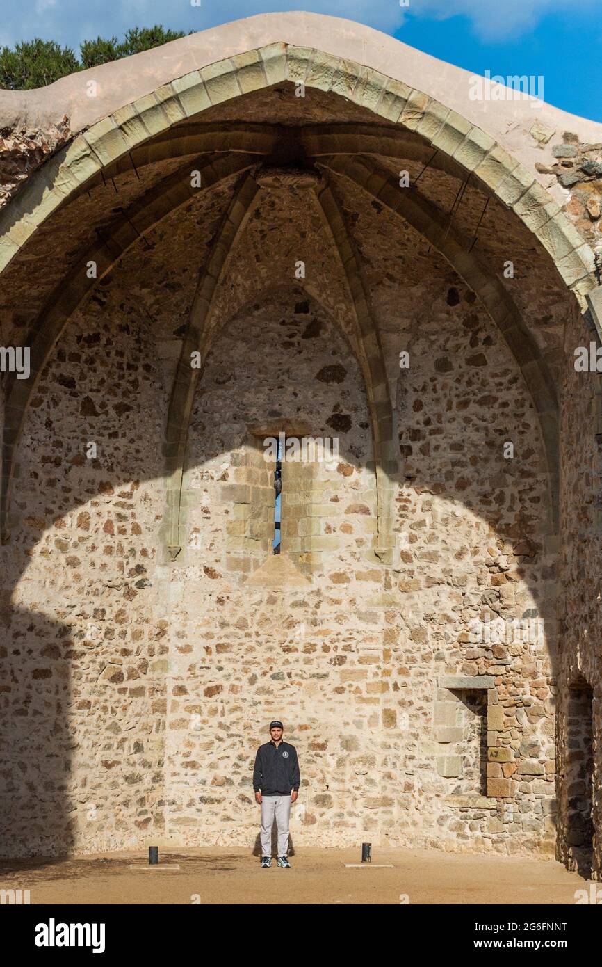Arnau Arús, DJ of artistic name poses in the ruins of the church in the walled area of Tossa de Mar, Costa Brava, Girona, Catalonia, Spain Stock Photo