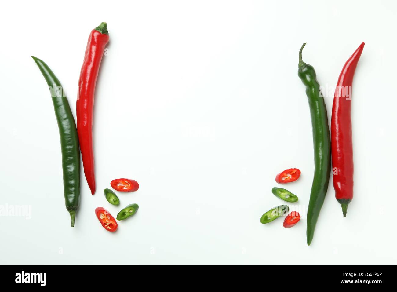Red and green peppers on white background Stock Photo - Alamy