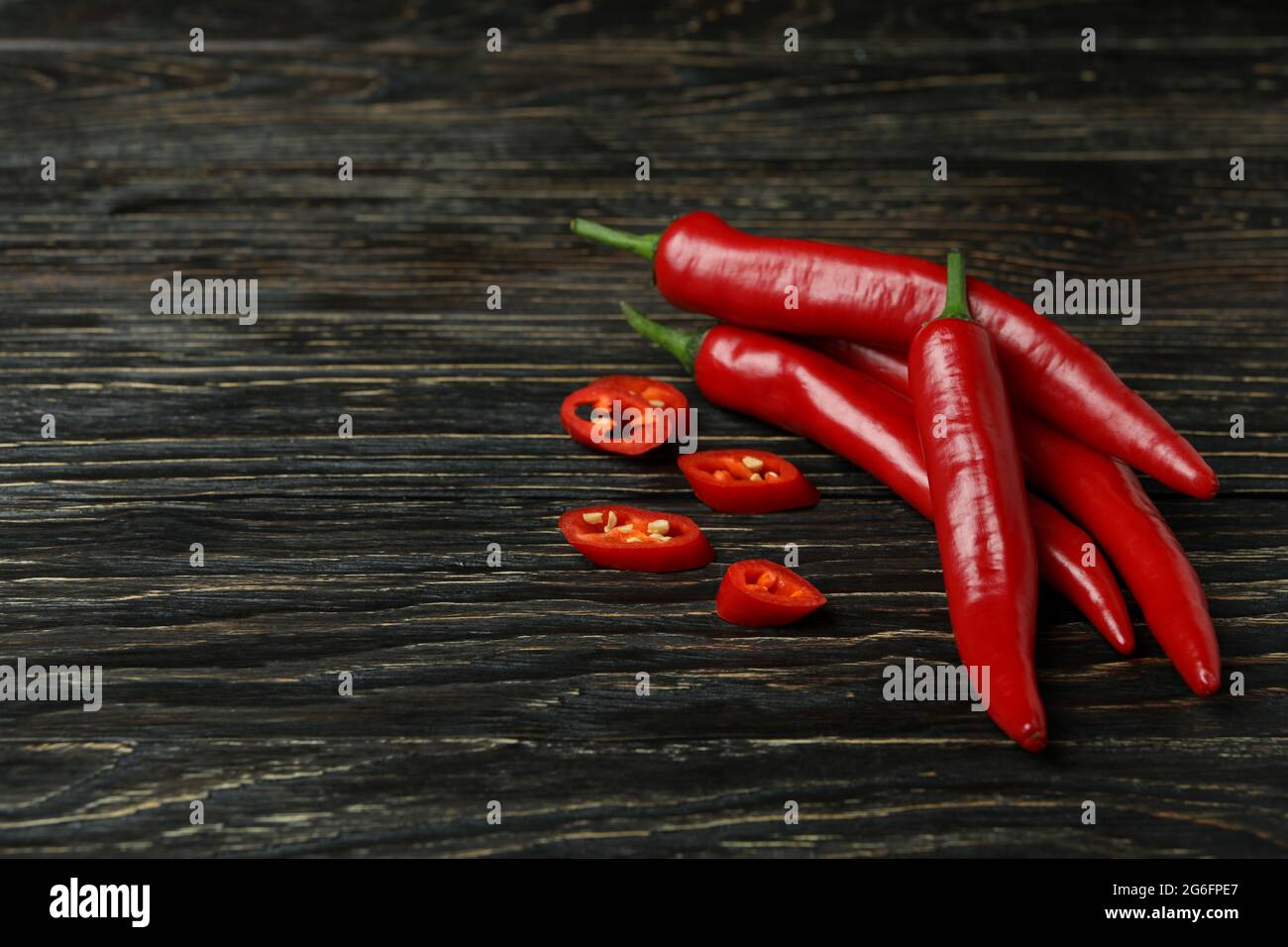 Red chili peppers on rustic wooden background Stock Photo - Alamy