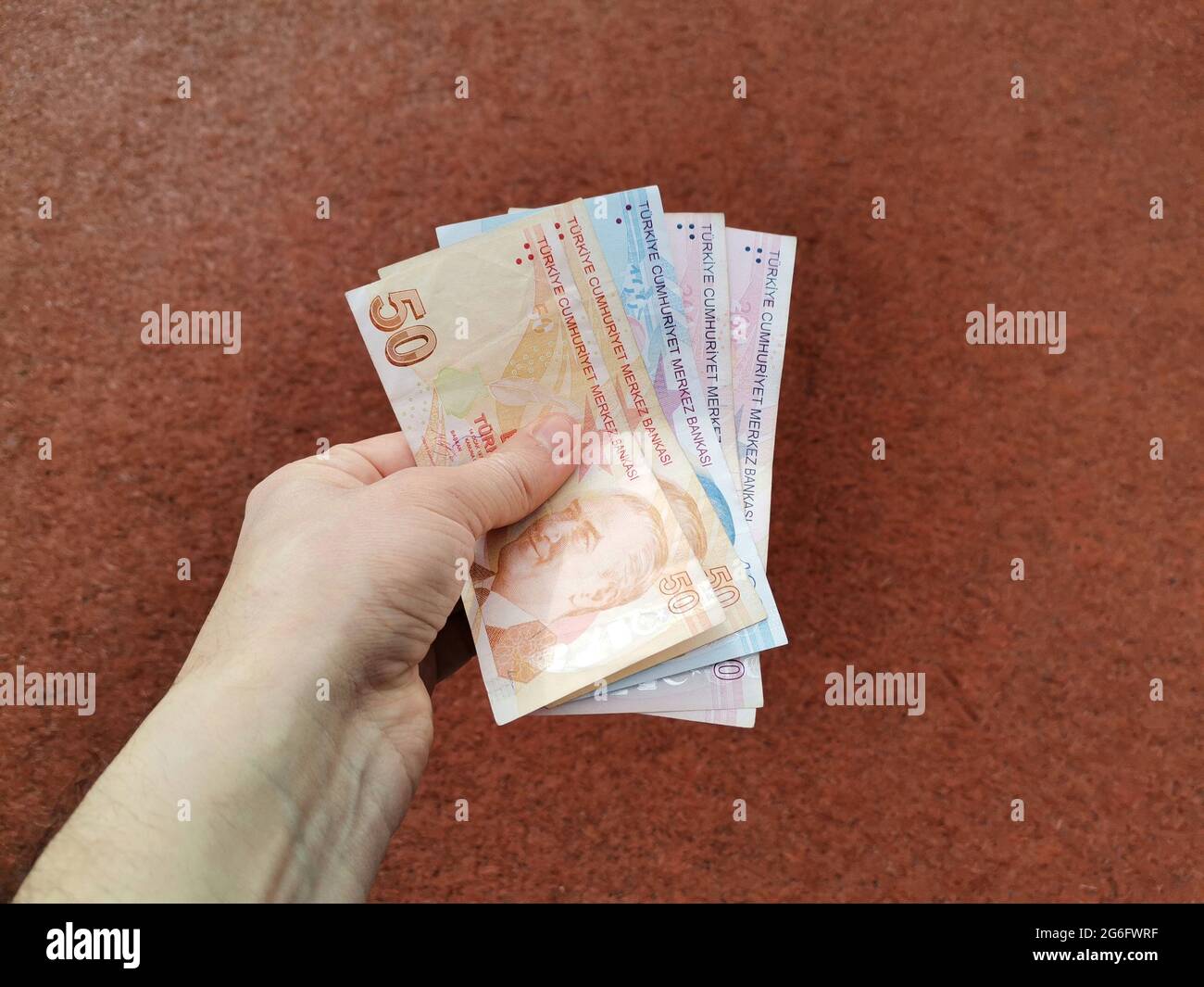 Hand holding Turkish money. Stock Photo