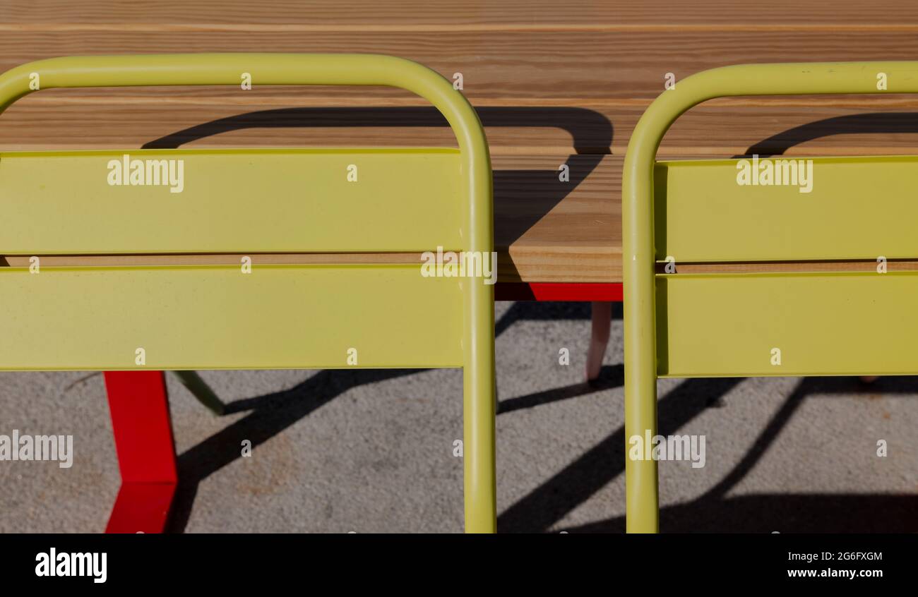 Yellow outdoor chairs and wood table Stock Photo Alamy