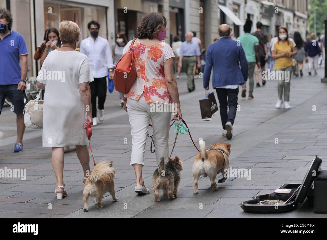 Peoples with dogs along Bergamo street center, Lombardy, Italy. Stock Photo