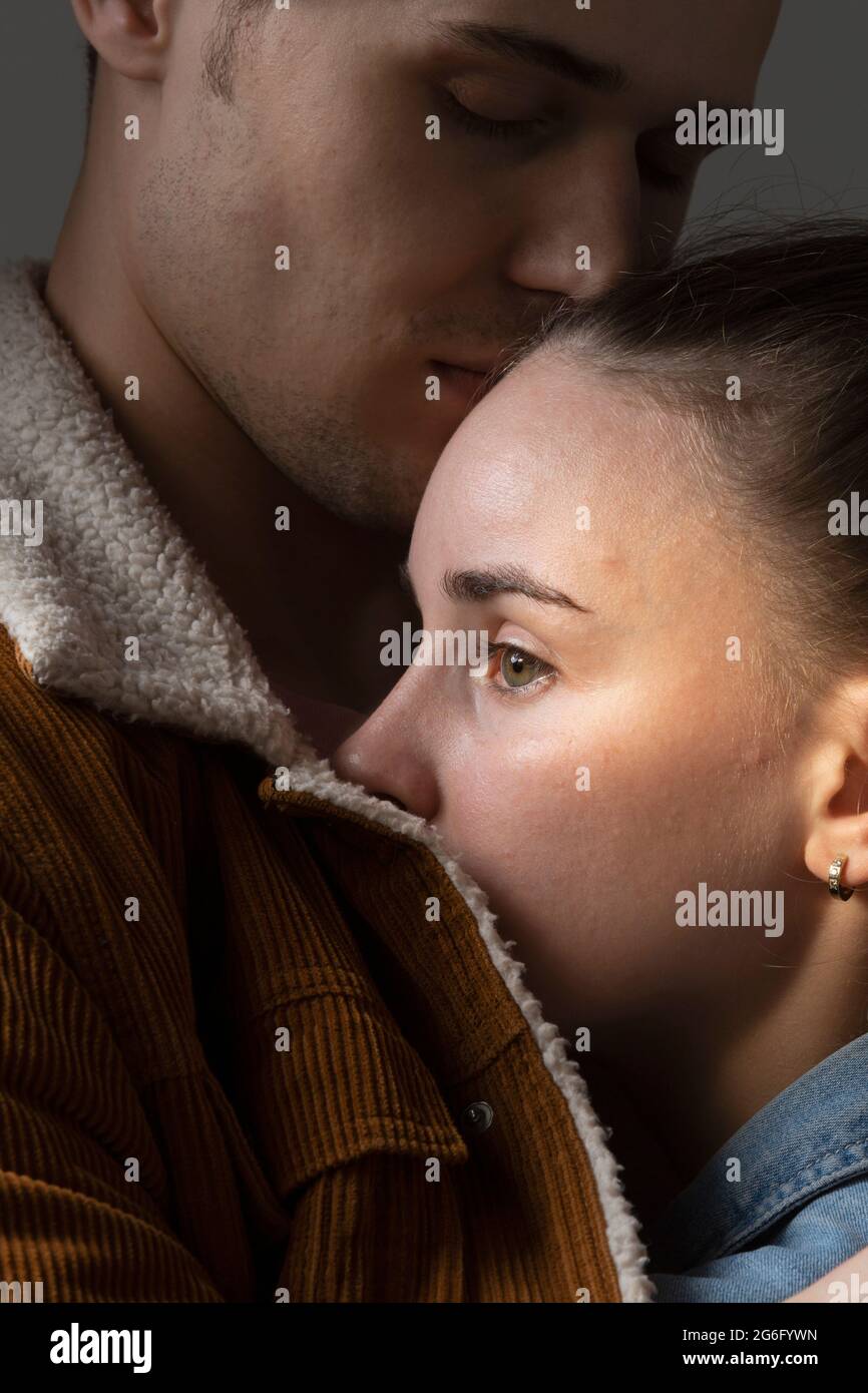 Close up boyfriend hugging worried girlfriend Stock Photo