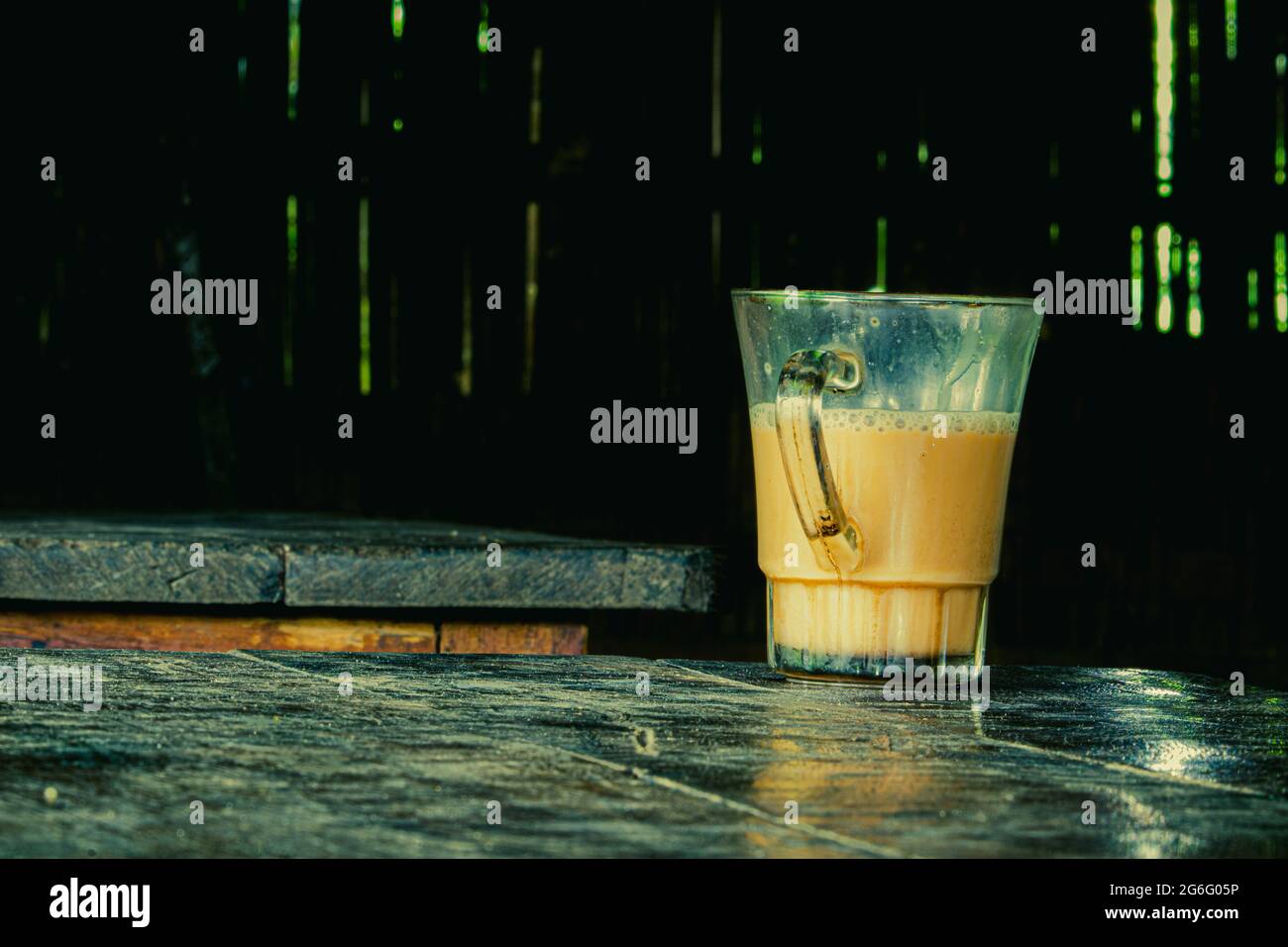 A glass cup filled with hot Tea on a table. On a tea shop in village. Stock Photo