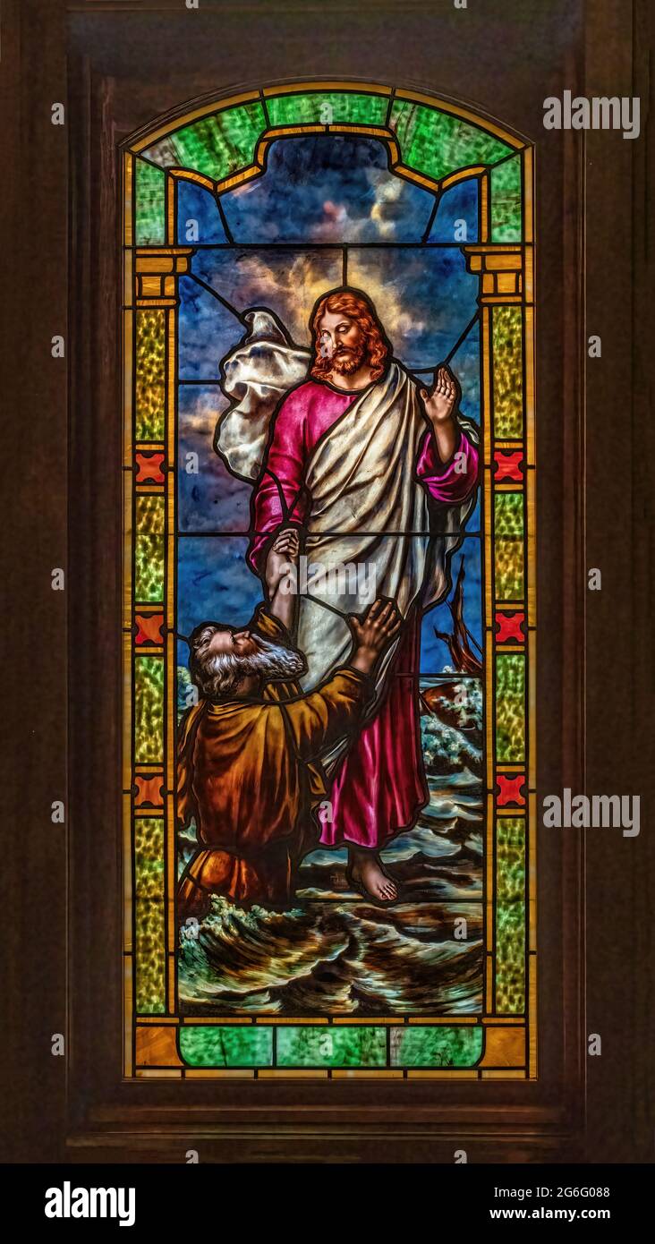 Stained glass at St. Joseph's Catholic Church picturing the miracle of Jesus walking on water with Peter calling out to Jesus, 'Lord, save me.' Stock Photo