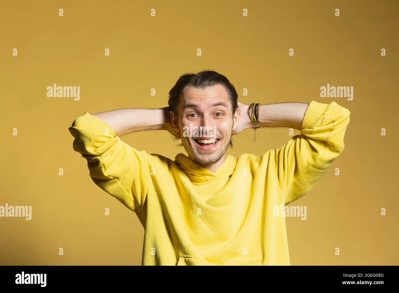 Portrait excited, happy young man on yellow background Stock Photo