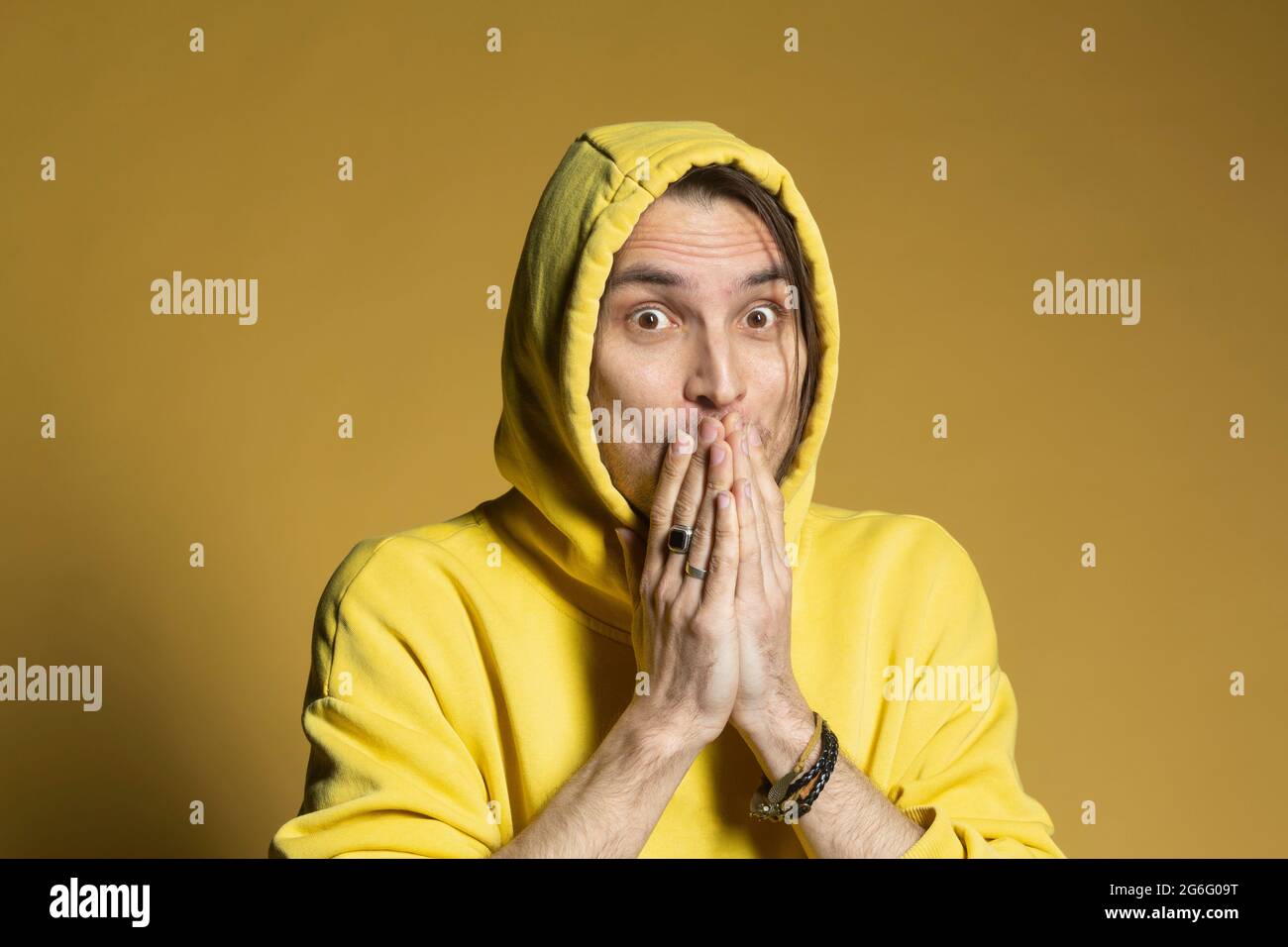 Portrait surprised wide eyed man with hands covering mouth Stock Photo