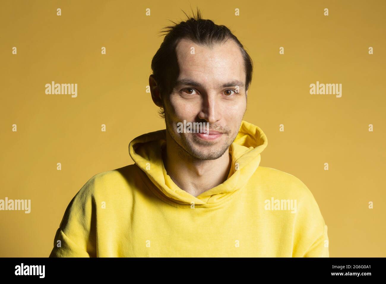 Portrait smiling man in yellow hooded sweatshirt Stock Photo