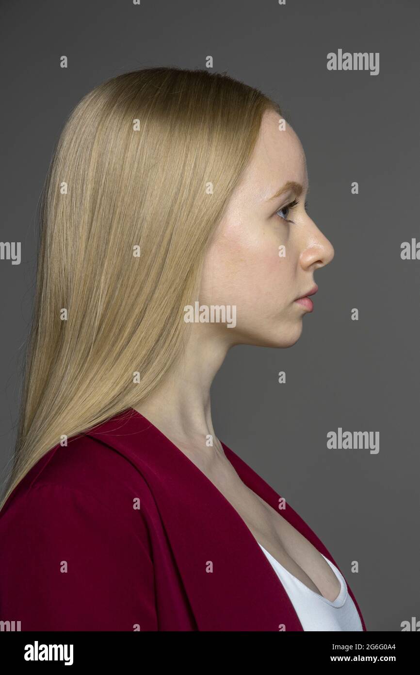 Profile portrait serious young woman with blonde hair Stock Photo