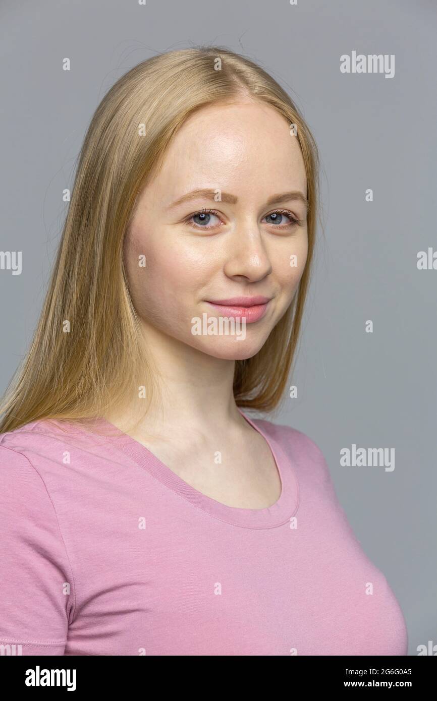 Close up studio portrait confident blonde young woman Stock Photo
