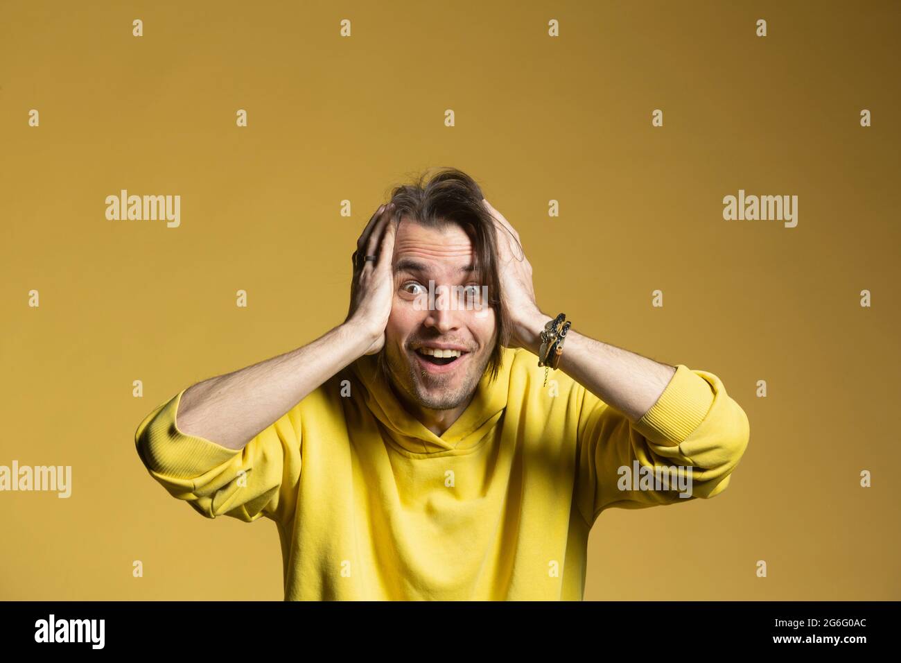 Portrait excited, surprised man on yellow background Stock Photo