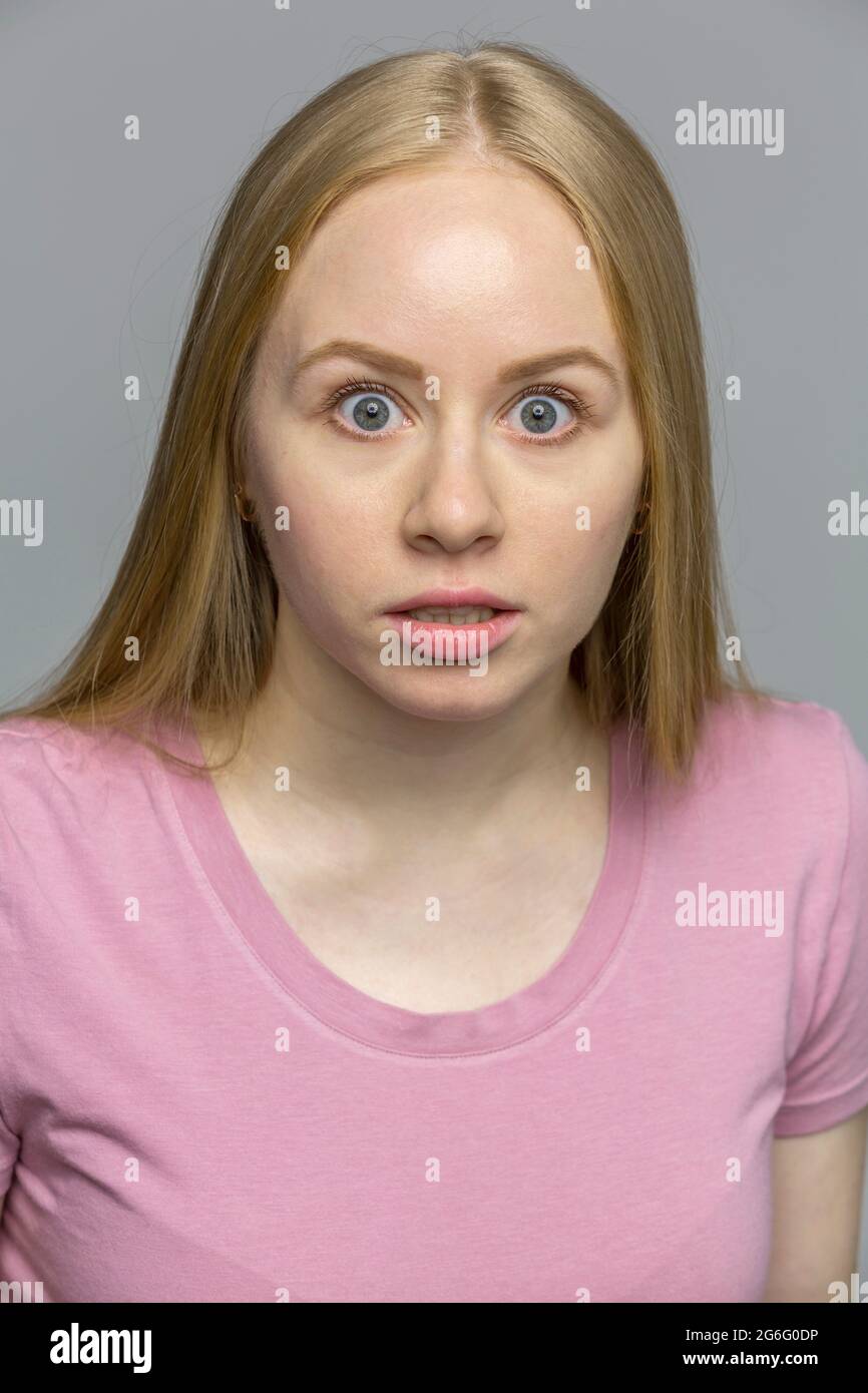 Portrait shocked, wide eyed young woman Stock Photo