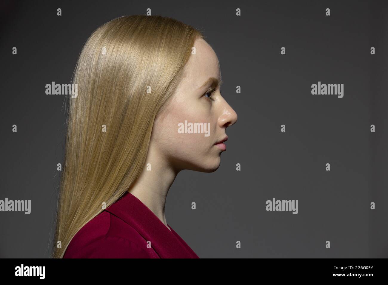 Profile portrait serious young woman with blonde hair Stock Photo
