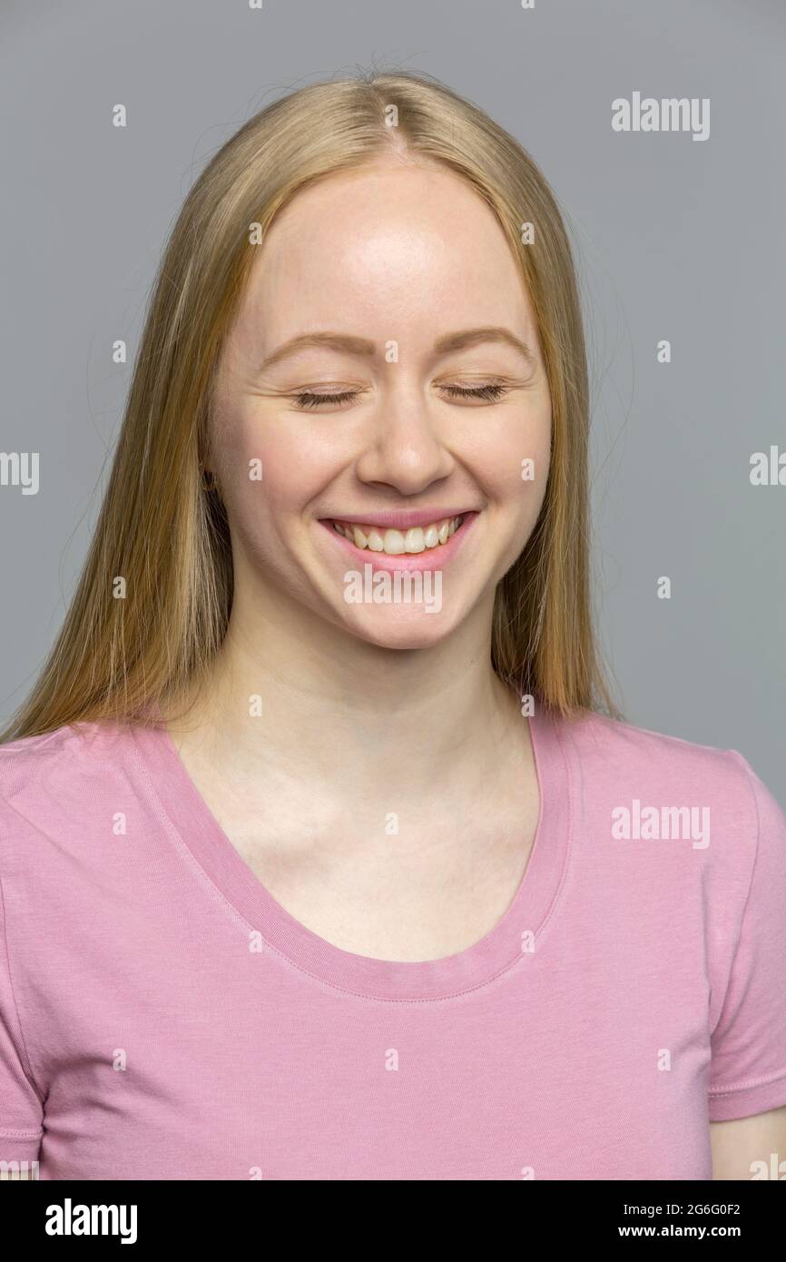 Portrait laughing young woman with eyes closed Stock Photo