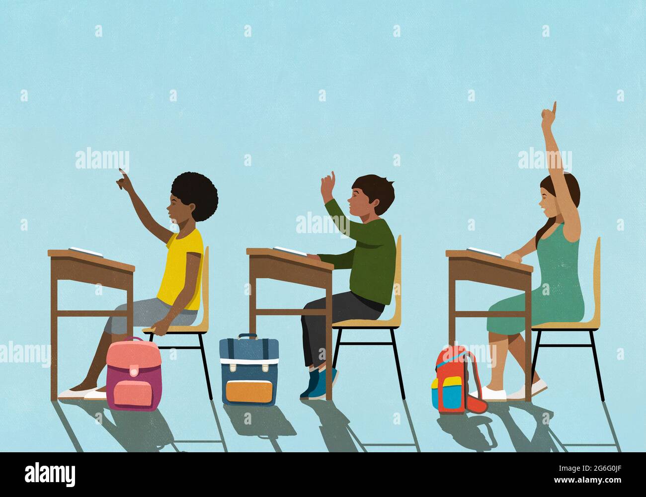 School children with arms raised at classroom desks stock photo alamy