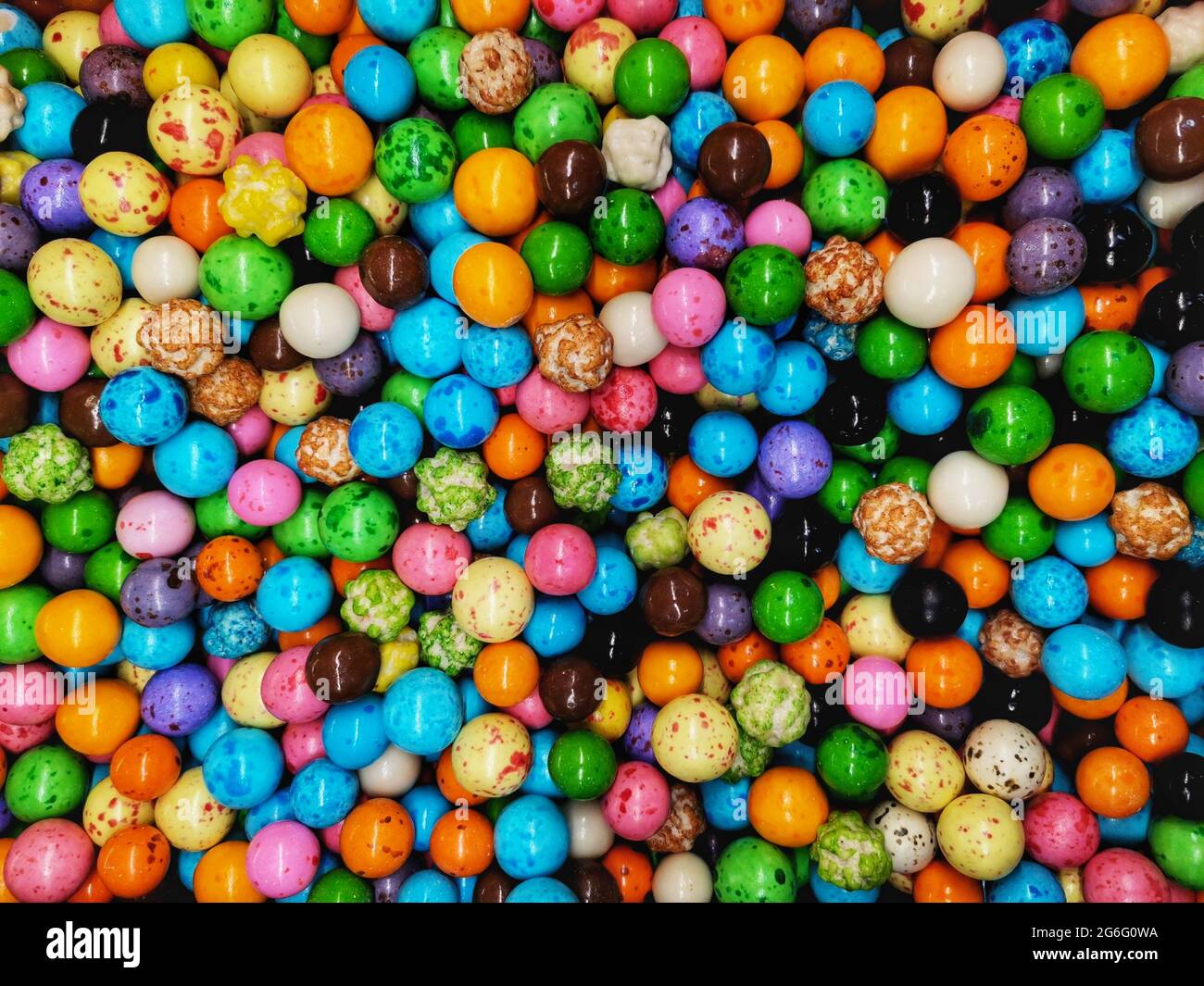 Closeup colored round chocolate. Background of small colored