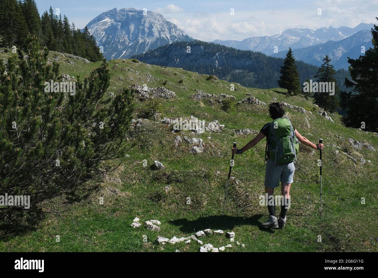 Woman hiking in idyllic sunny mountains, Bavaria, Germany Stock Photo