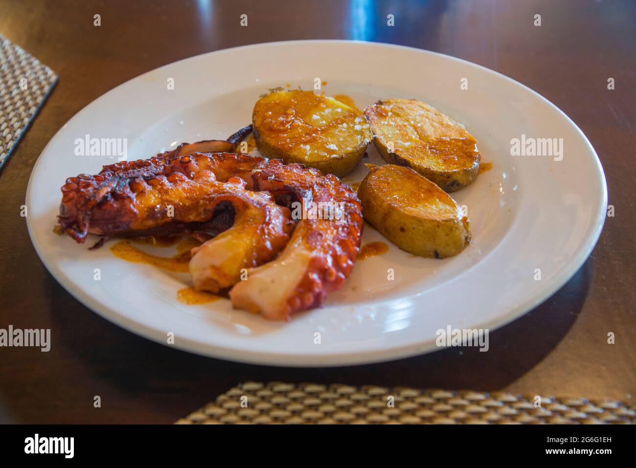 Grilled octopus with potatoes. Spain. Stock Photo