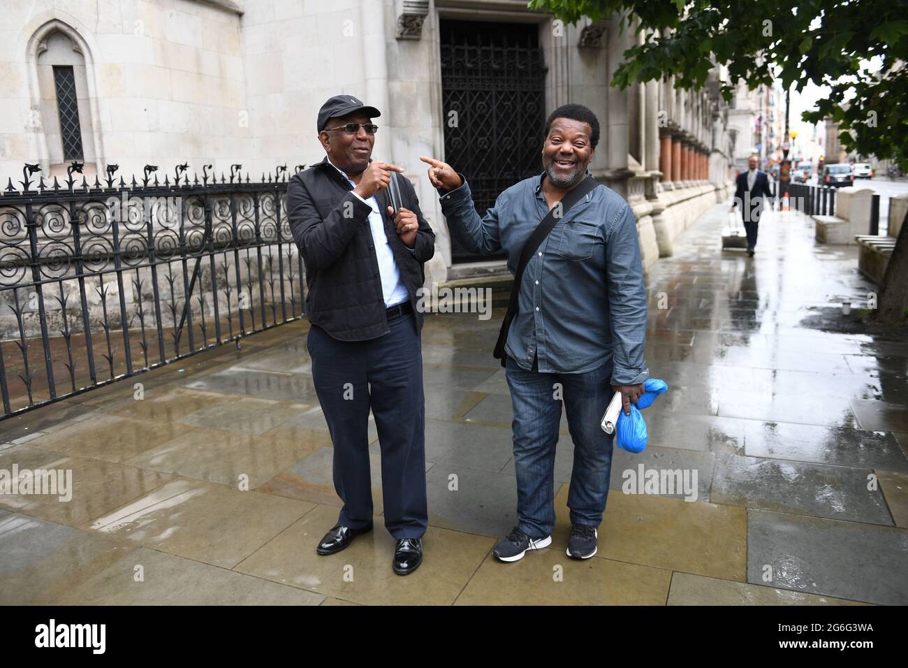 Paul Green (left) and Cleveland Davidson outside the Royal Courts of  Justice in London. The pair along with Courtney Harriot, were jailed for  allegedly attempting to rob a corrupt police officer nearly