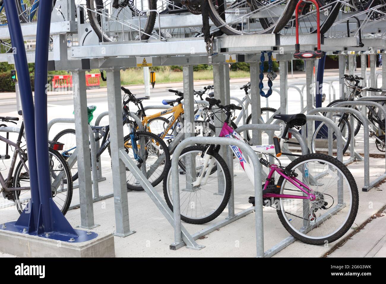 Commuting & Transport concept - Bicycles left securely in cycle rack next to Basildon Rail Station Stock Photo