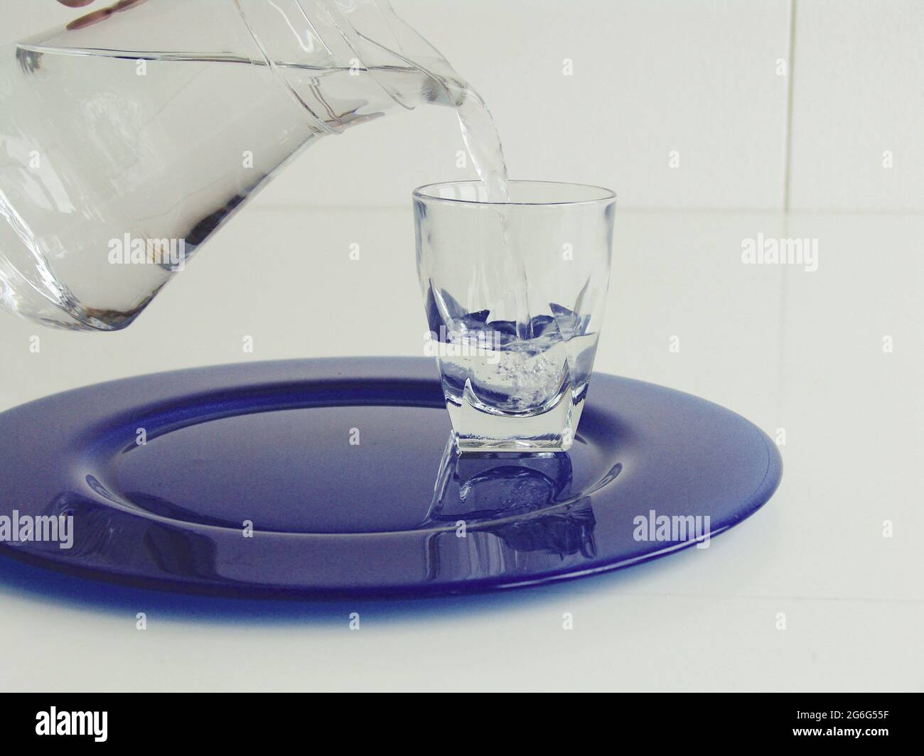 https://c8.alamy.com/comp/2G6G55F/pouring-water-into-a-water-glass-with-a-carafe-2G6G55F.jpg