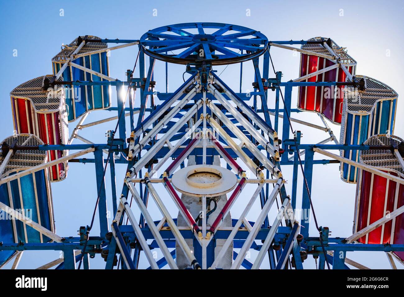 The zipper ride at a carnival against a blue sky. Stock Photo