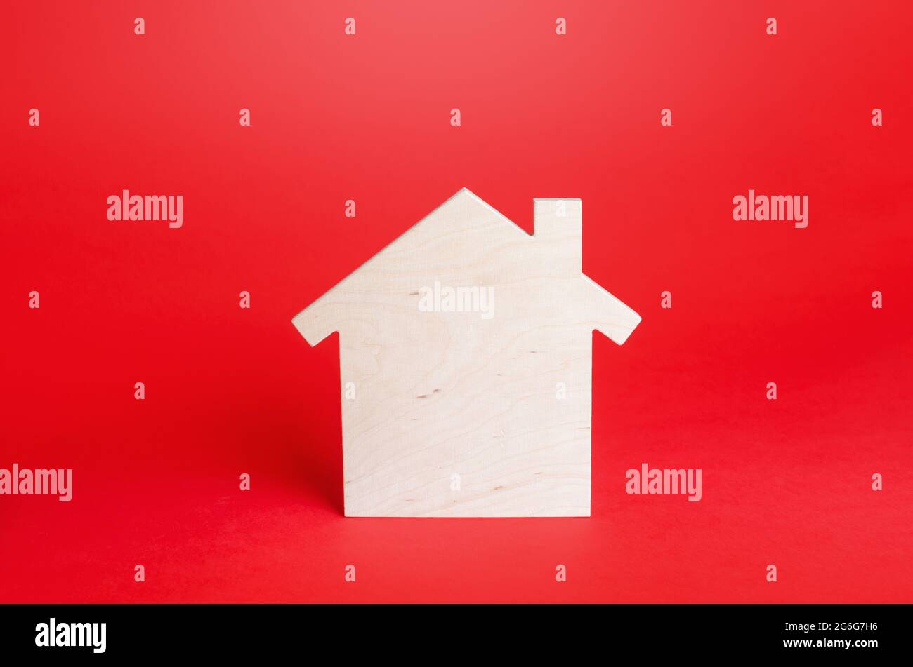 Empty blank wooden house on red background. Buying and selling real estate. Housing, realtor services. Renovation and home improvement. Short and long Stock Photo