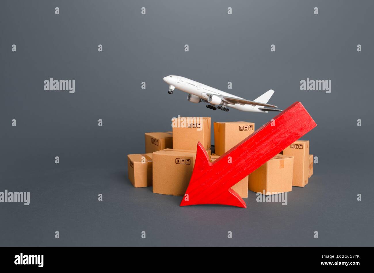 Airplane over boxes and red down arrow. Decline of goods transportation volume, world trade traffic delays. Delivery by air. High demand and low propo Stock Photo