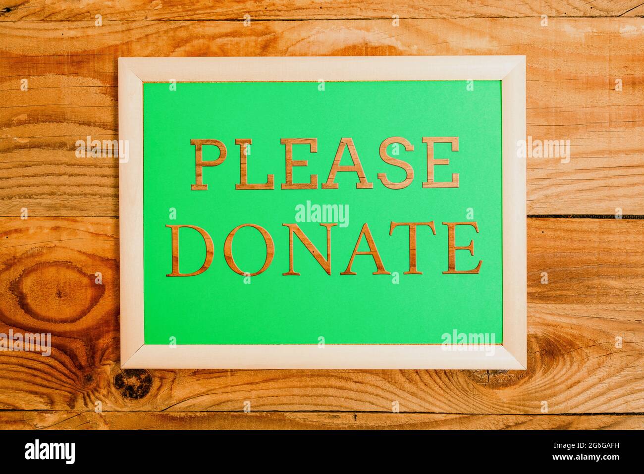 Please donate words written on white board Stock Photo - Alamy