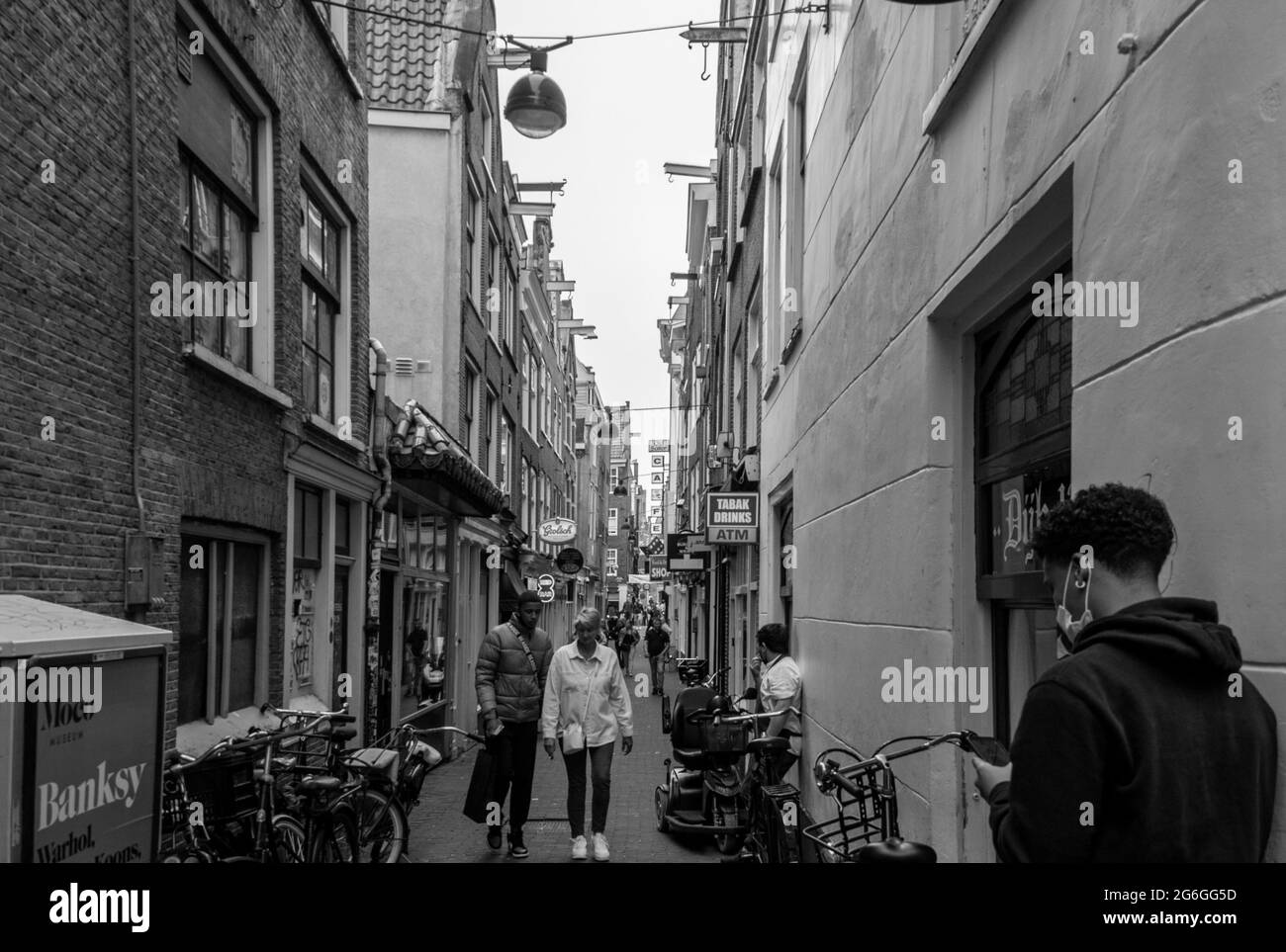 AMSTERDAM, NETHERLANDS. JUNE 06, 2021. View to the small street Black and white photography. Stock Photo