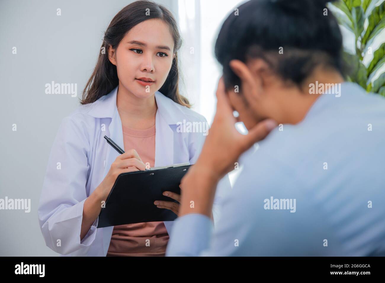 Asian woman professional psychologist doctor write, note on paper and