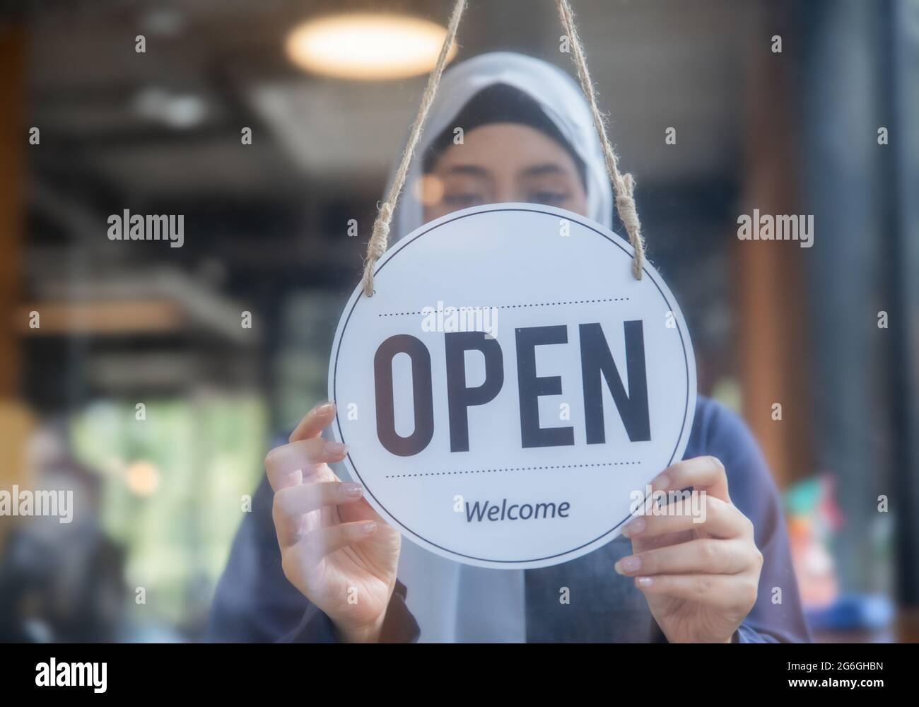 coffee café staff, Muslim employee woman hang on open sign on glass