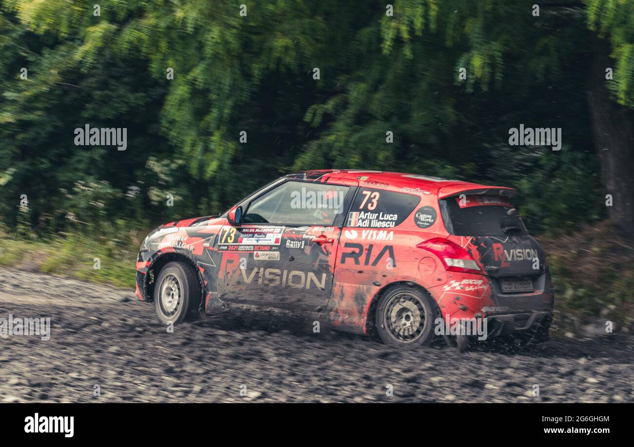 Action shot of rally car during a competition on muddy forst tracks ...