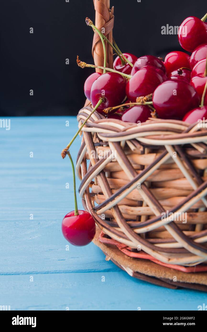 Vertical shot ripe red cherries in the wicker basket Stock Photo - Alamy