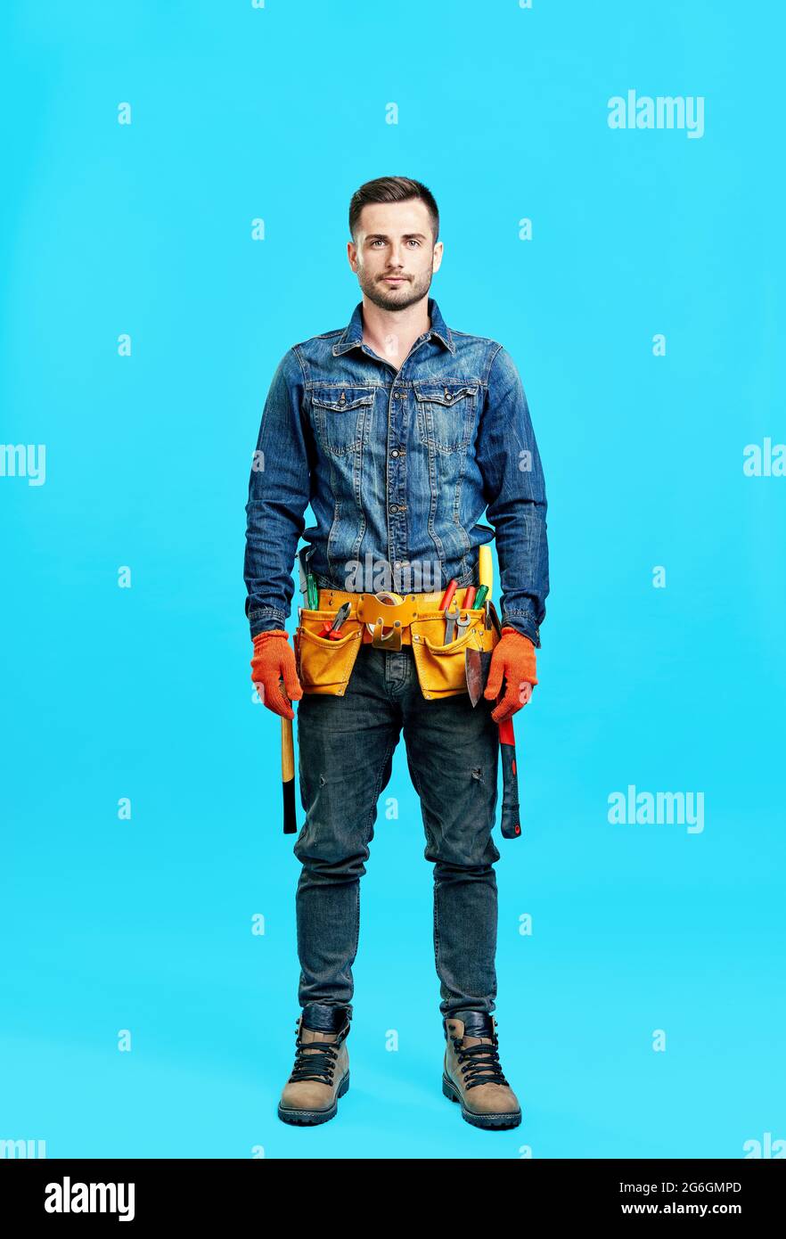 Full length portrait of handsome young male construction worker staying ...