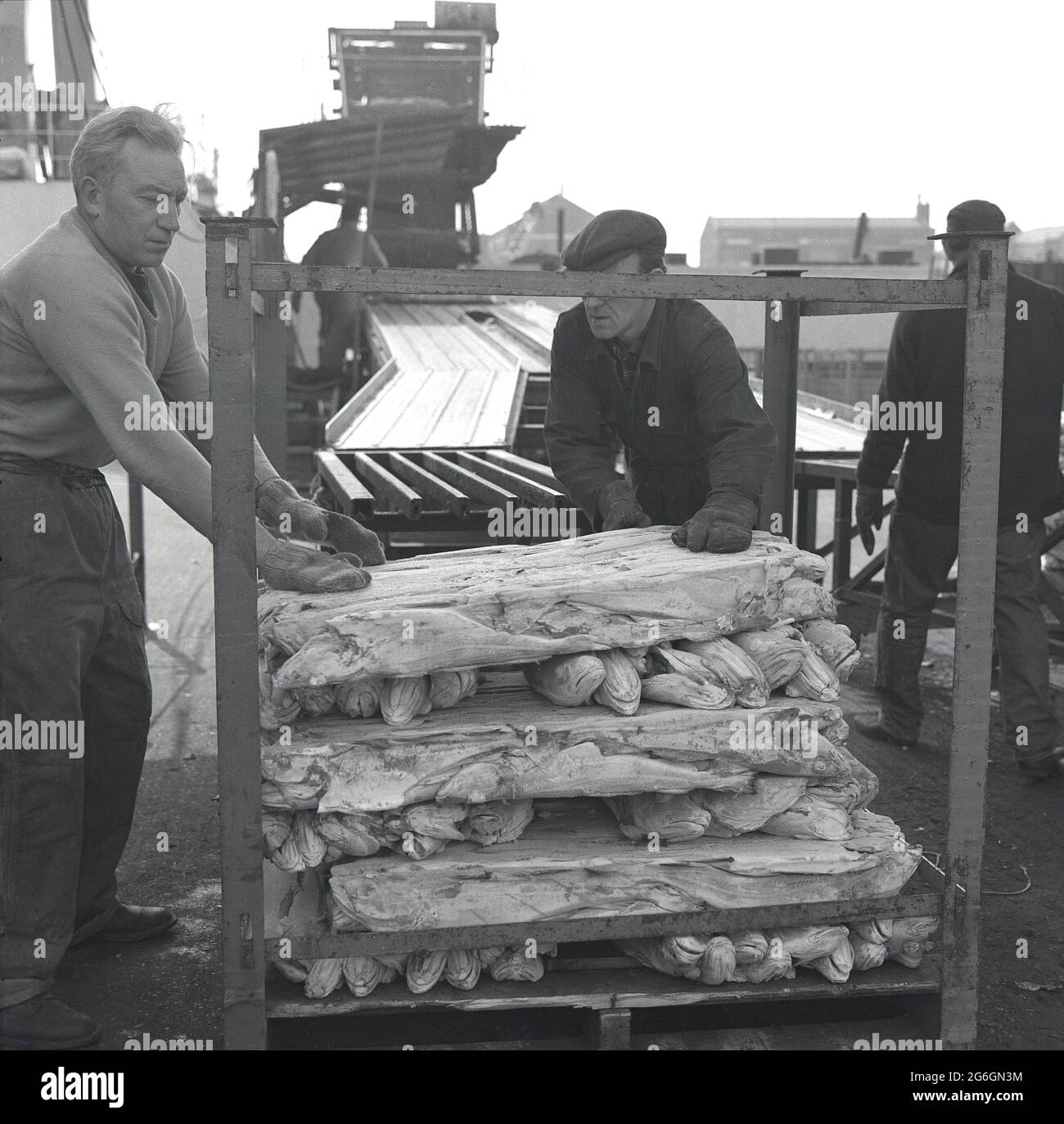 1960s, historical, outside at the docks, workers wearing gloves, moving