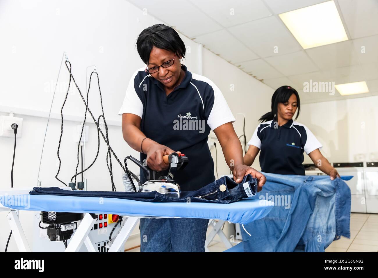 Johannesburg, South Africa October 2, 2012 Young Black woman ironing
