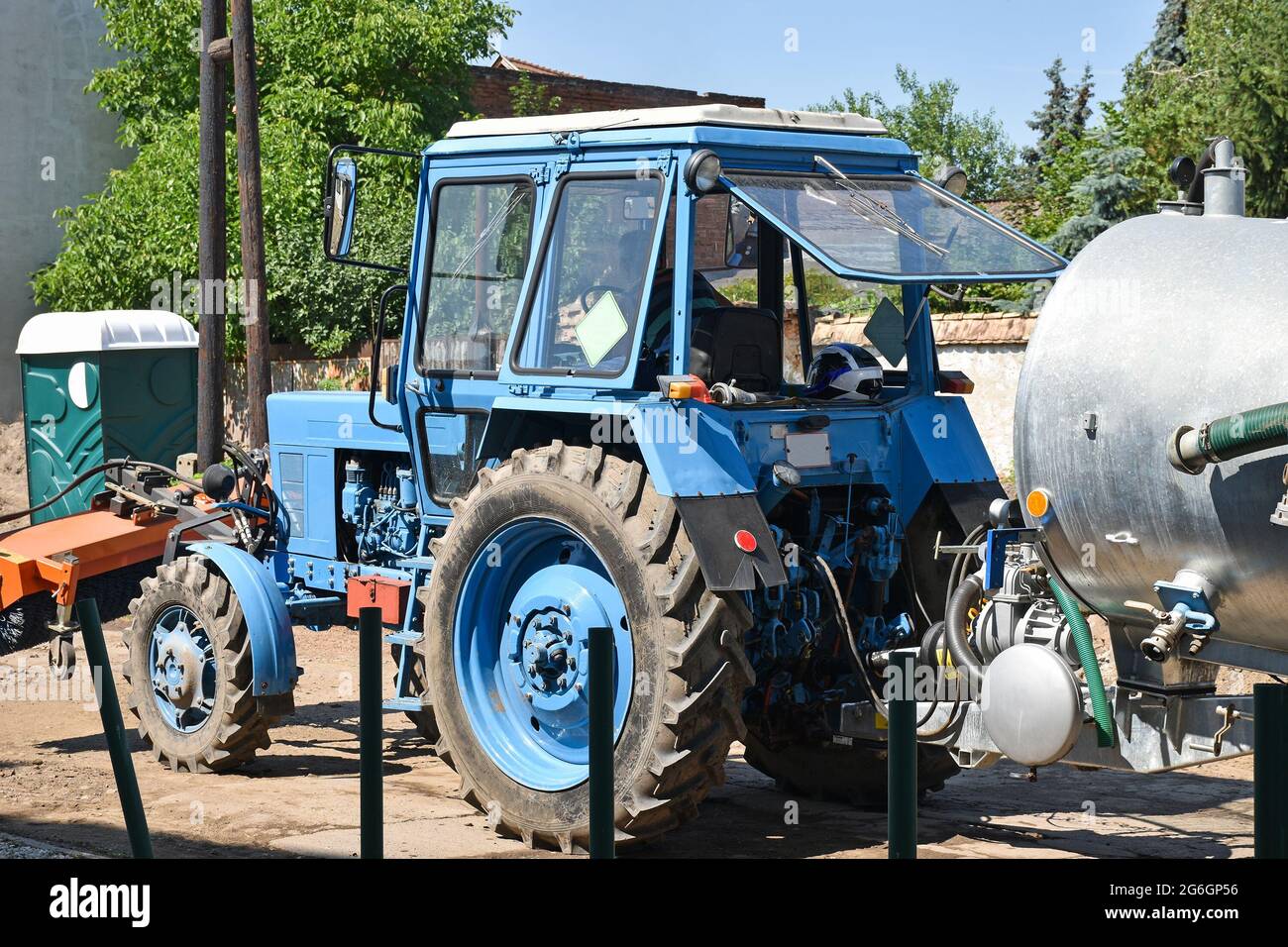 Tractor and watering container at the road construction Stock Photo Alamy