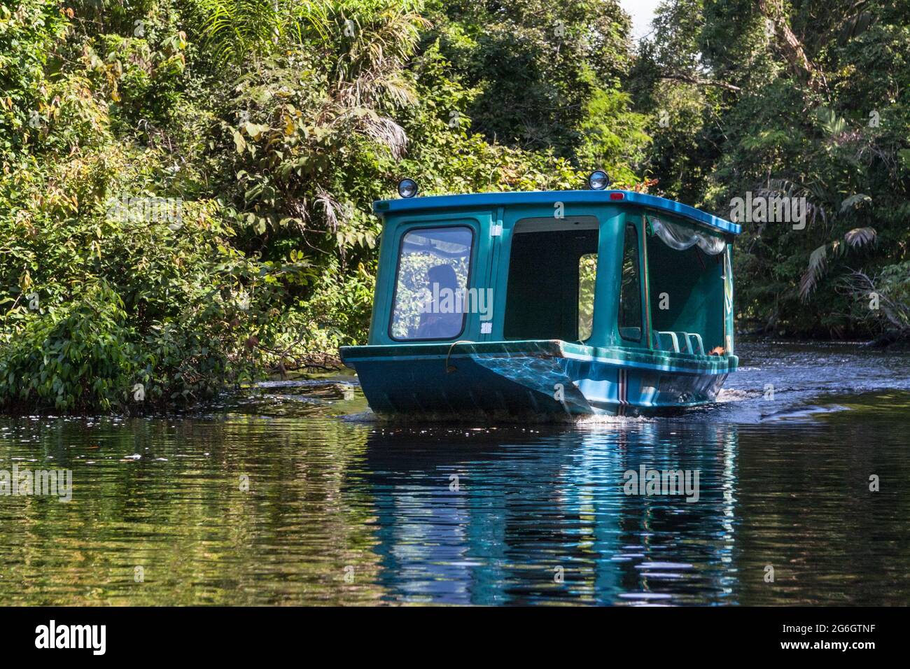 Tour boat on a freshwater canal in Tortugero National Park, Limon, Costa Rica Stock Photo