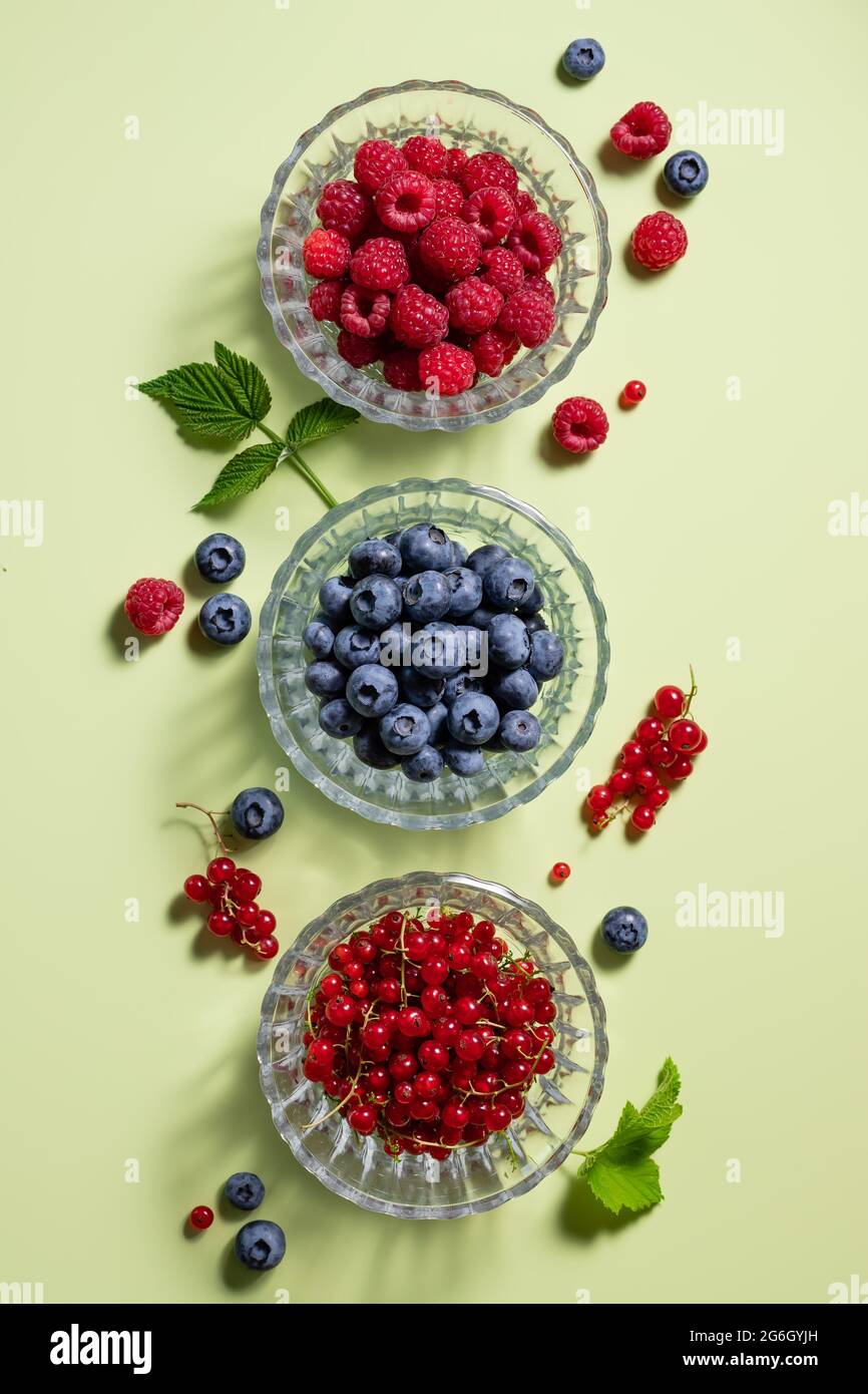 flat lay composition with different berries on green background Stock Photo