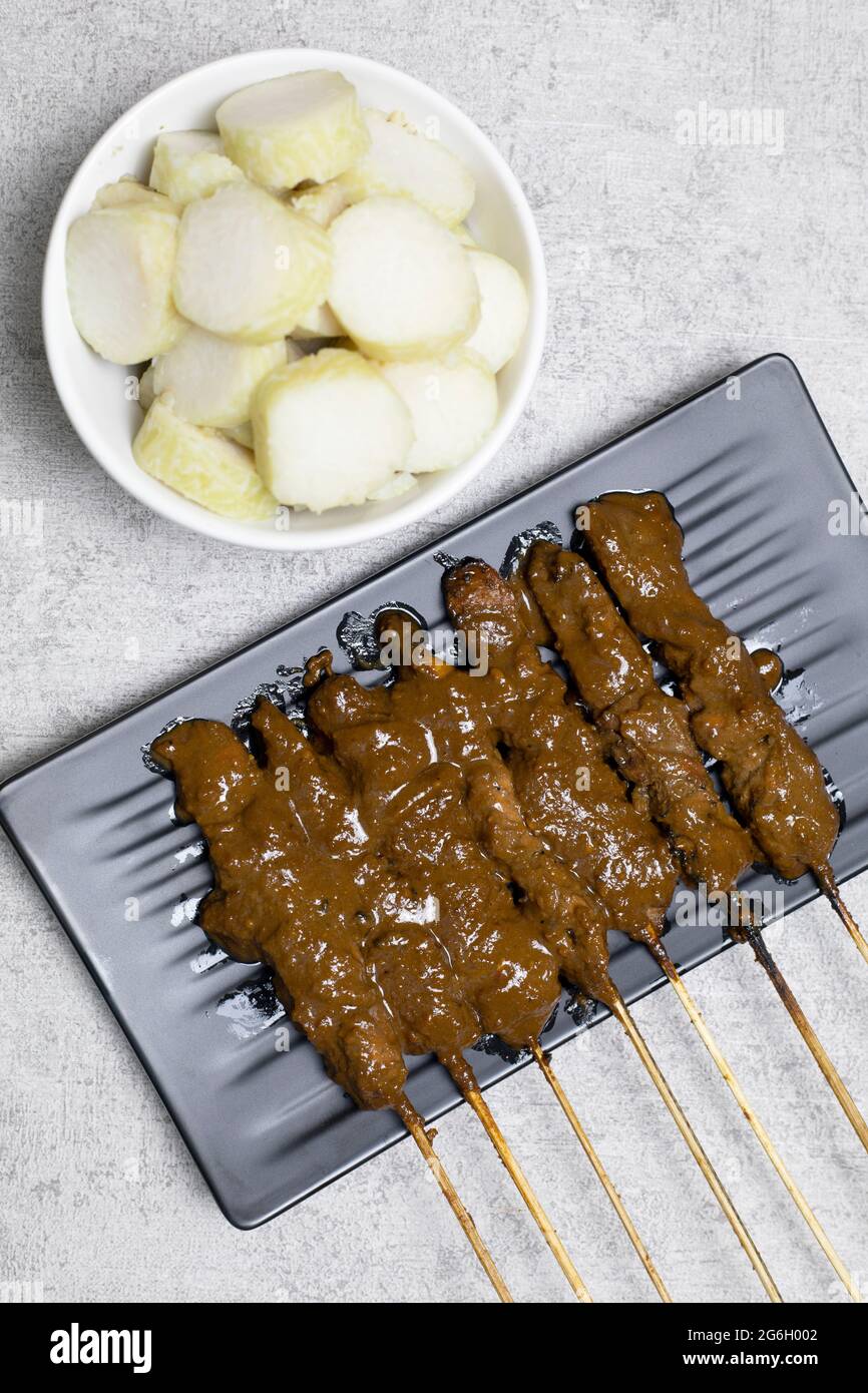 Chicken satay (sate ayam) with Lontong and peanut sauce Stock Photo