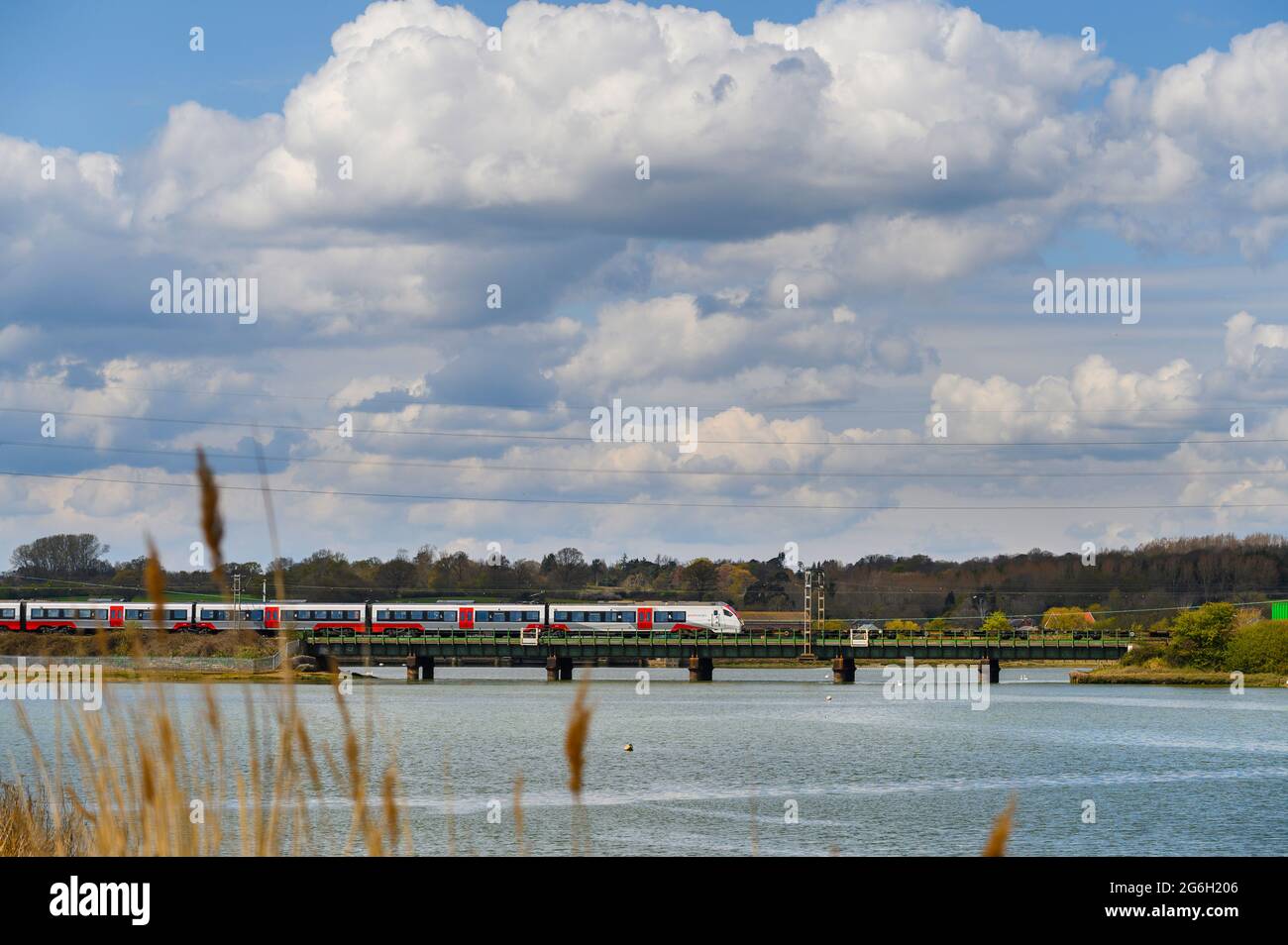 Class 745 passenger train in Greater Anglia livery crossing the Manningtree Viaduct, across the River Stour, Essex, England. Stock Photo