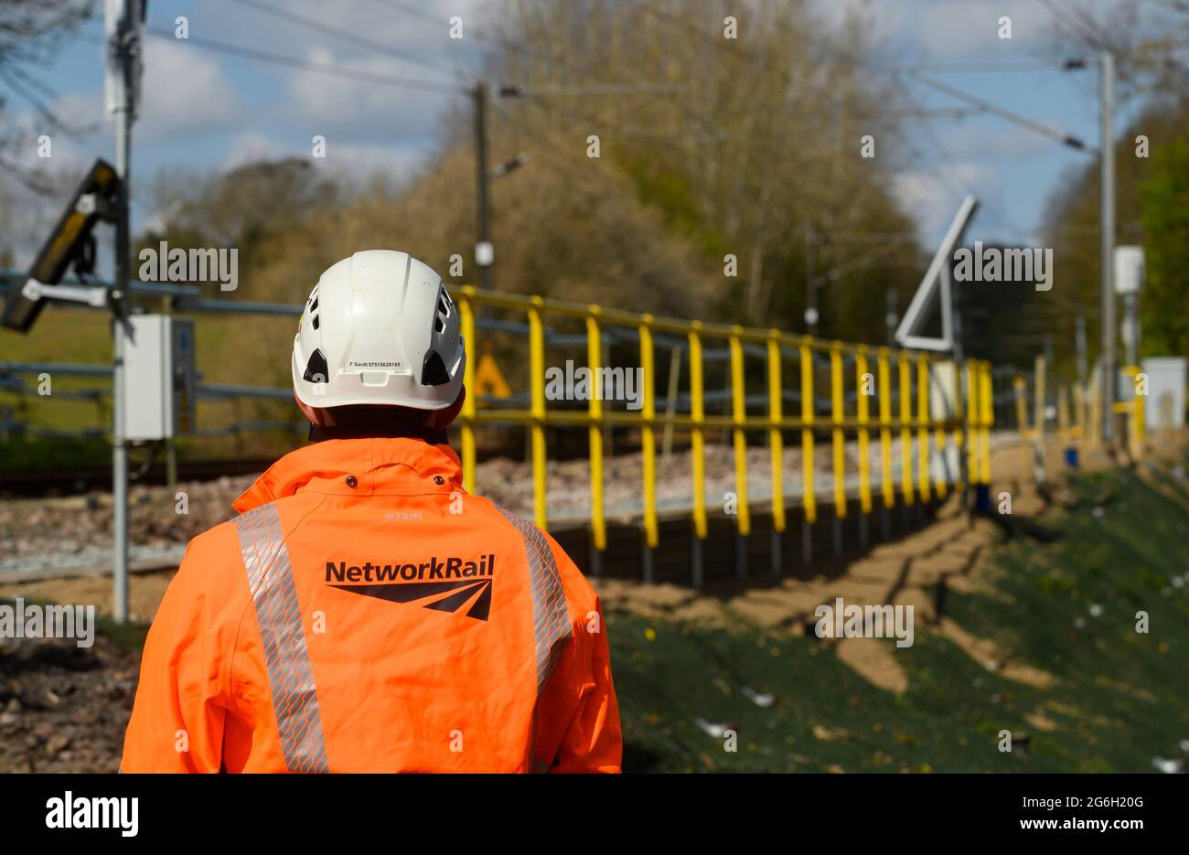 Network Rail worker standing at the side of rail track in Manningtree, Essex, England. Stock Photo