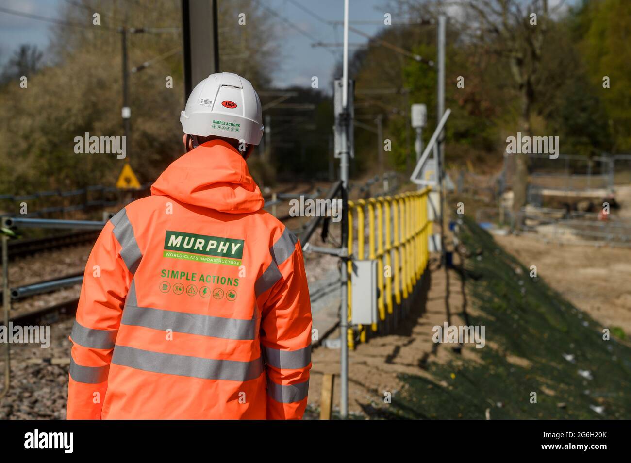 Track worker standing at the side of rail track in Manningtree, Essex, England. Stock Photo