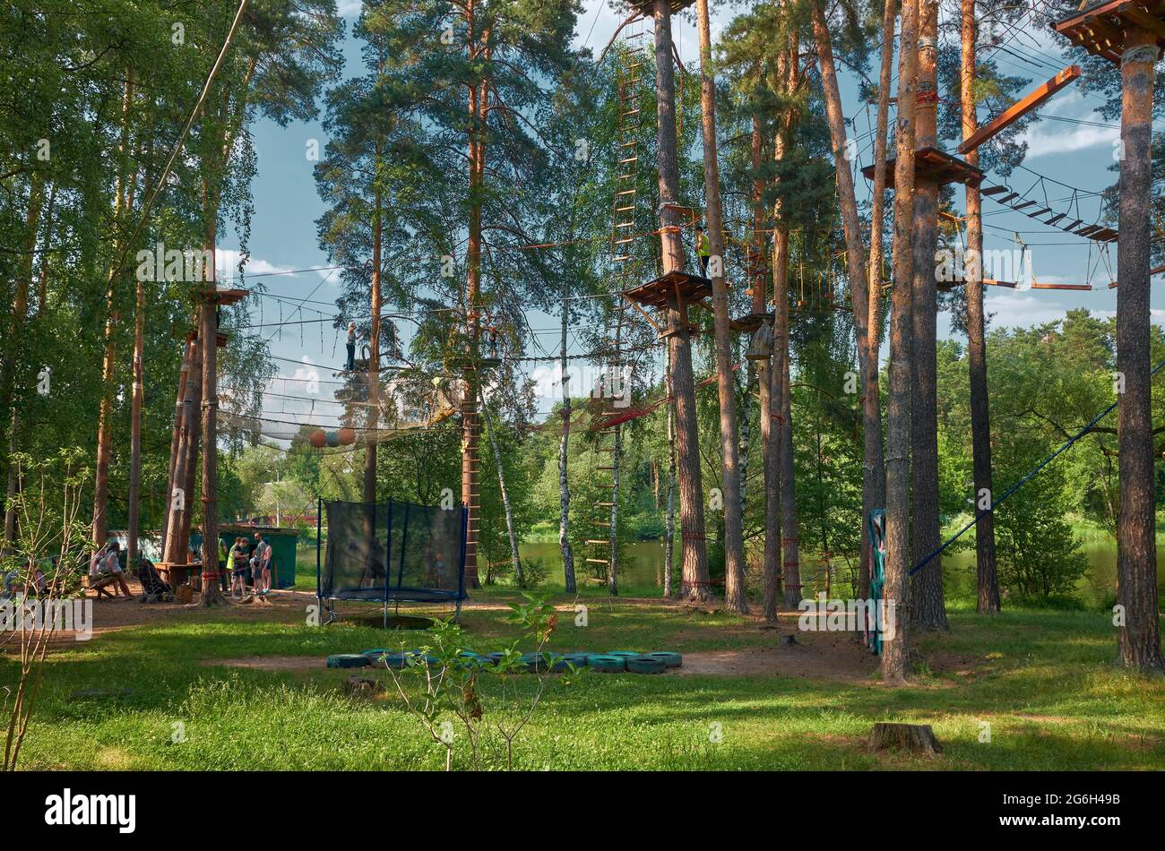 Heavenly Path rope park in the tops of pine trees on the shore of Kratovskoye Lake, family entertainment and recreation: Kratovo, Russia - June 15, 20 Stock Photo