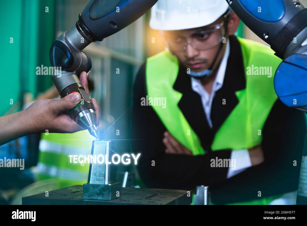 Asian engineers male female in Industrial wear hard hats in Industry manufacturing factory mechanical display interface arm robot manufacturing indust Stock Photo